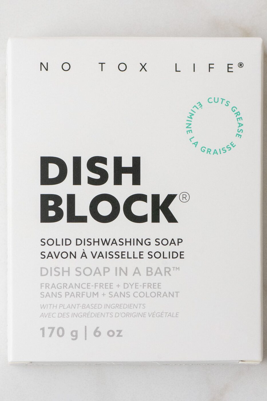 Solid dish washing soap block in cardboard packaging