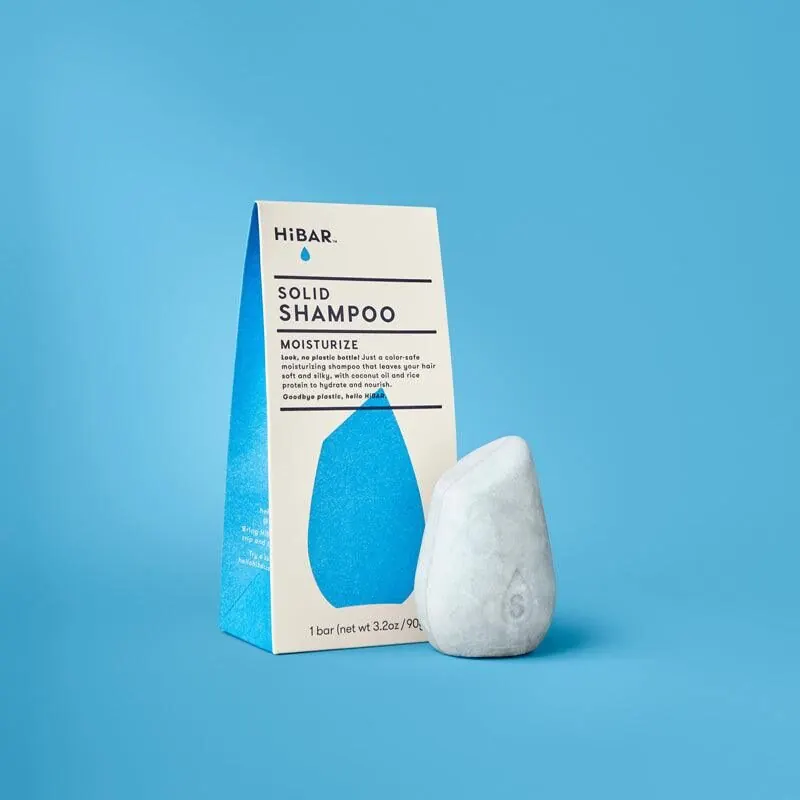 Solid shampoo bar on a wooden dish