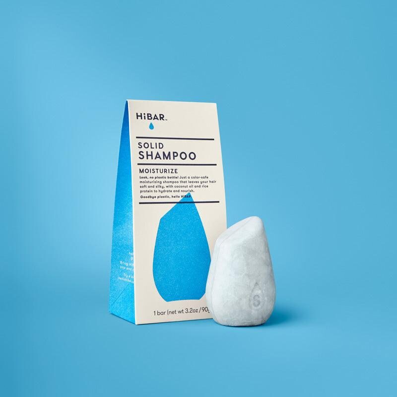 Solid shampoo bar on a wooden dish